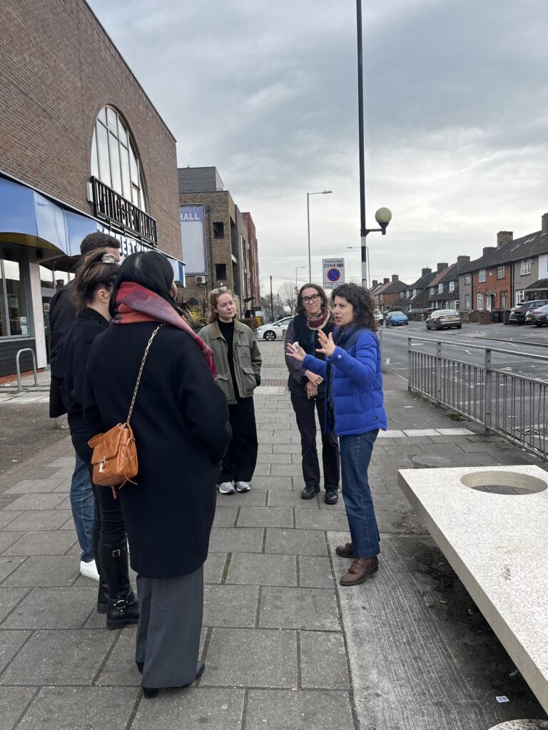 Kate talking animatedly to a group of people on a tour of Barking and Dagenham
