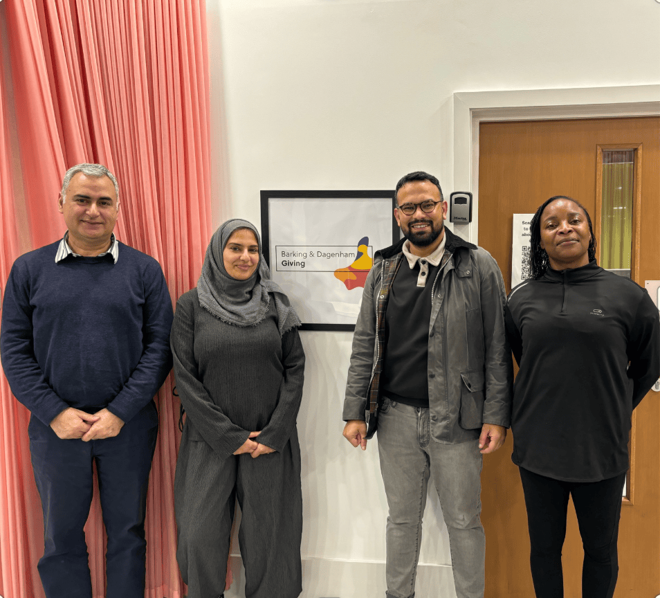 A group of four residents stood in BD Givings offices