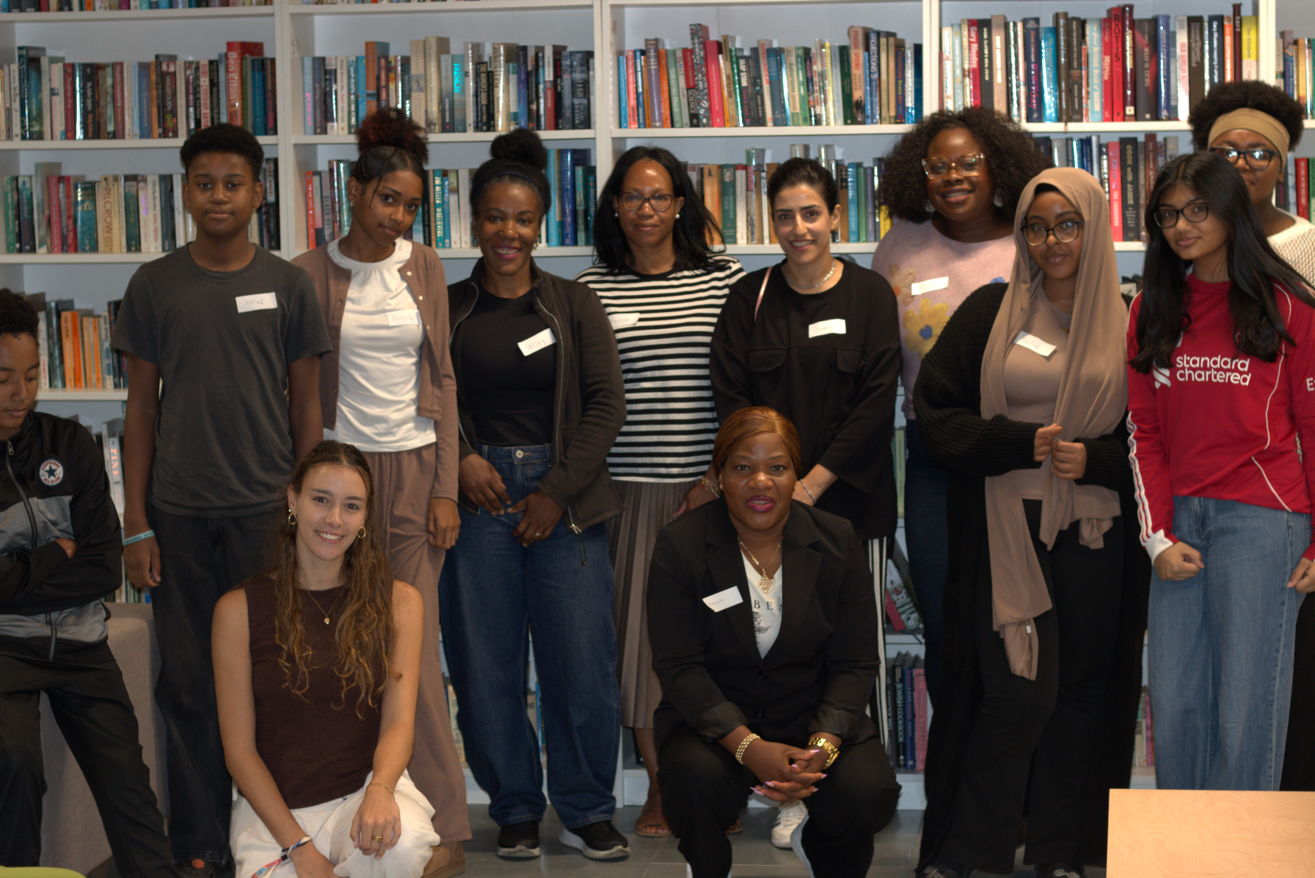 Resident decision-makers lined up infront of a book shelf
